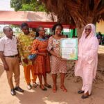 Dzifa Gomashie receives a citation after handing over the renovated Ansaru Islamic School to the community