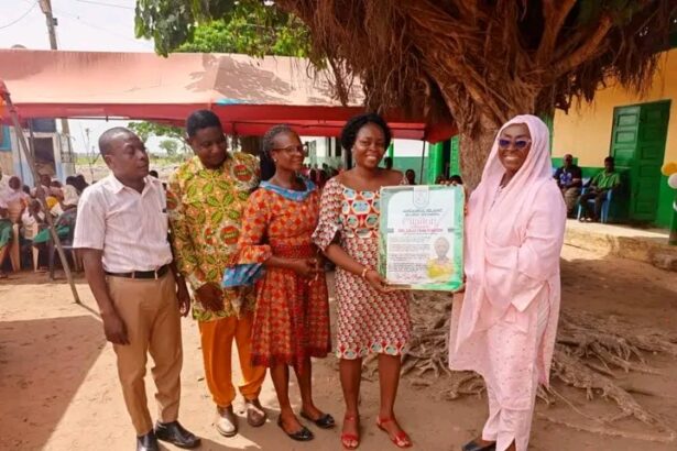 Dzifa Gomashie receives a citation after handing over the renovated Ansaru Islamic School to the community