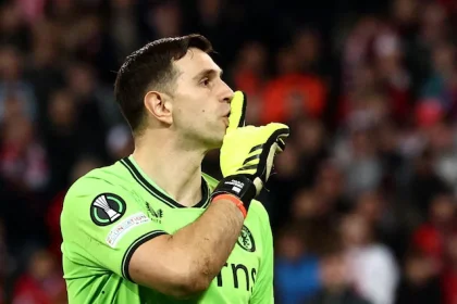 Emiliano Martinez shushes Lille fans during the Europa Conference League quarter-final match between Lille and Aston Villa