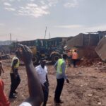 Traders watch as REGSEC demolish the Kwadaso Onion Market in the Ashanti Region