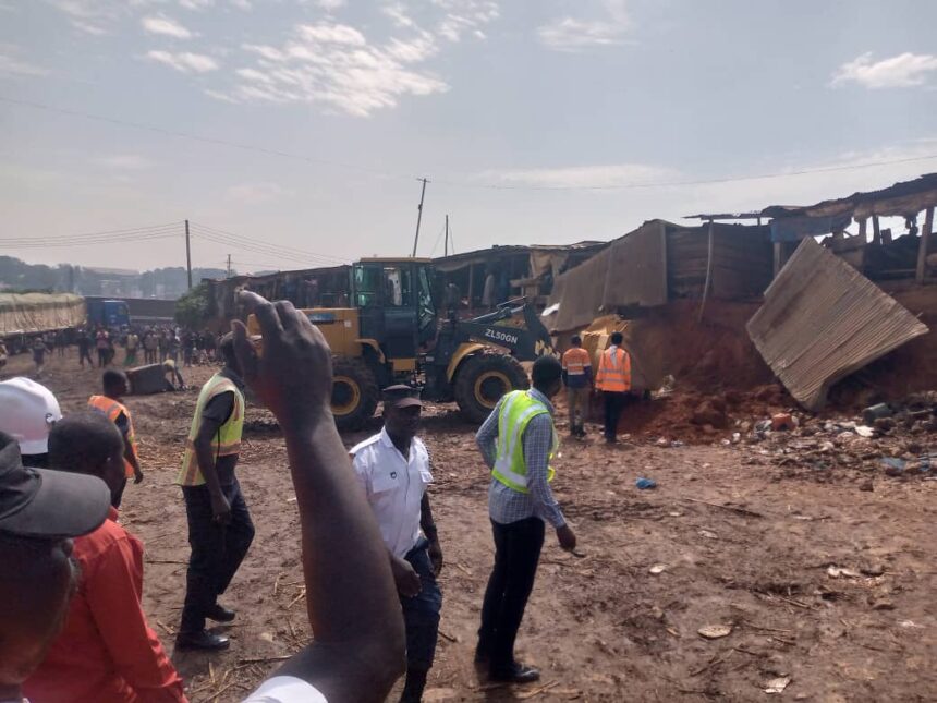 Traders watch as REGSEC demolish the Kwadaso Onion Market in the Ashanti Region