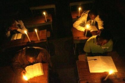 students studying in the dark with candle lights