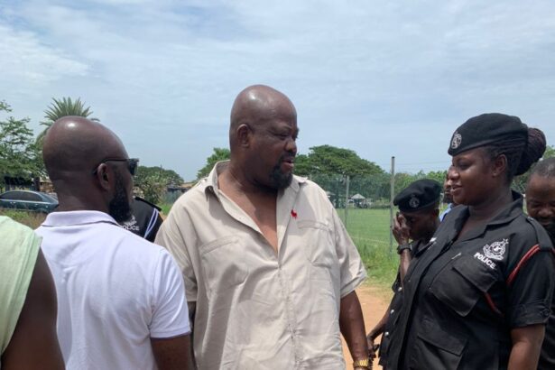Joshua Akamba interacting with Police officers at a limited voter registration centre