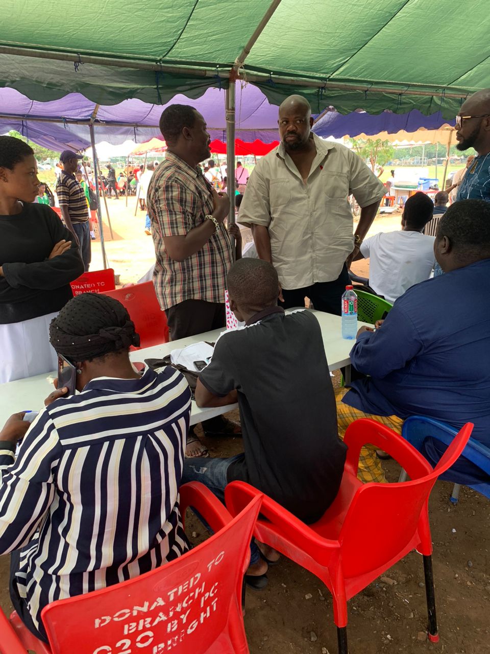 Joshua Akamba interacts with officials during a tour of the limited voter registration centres