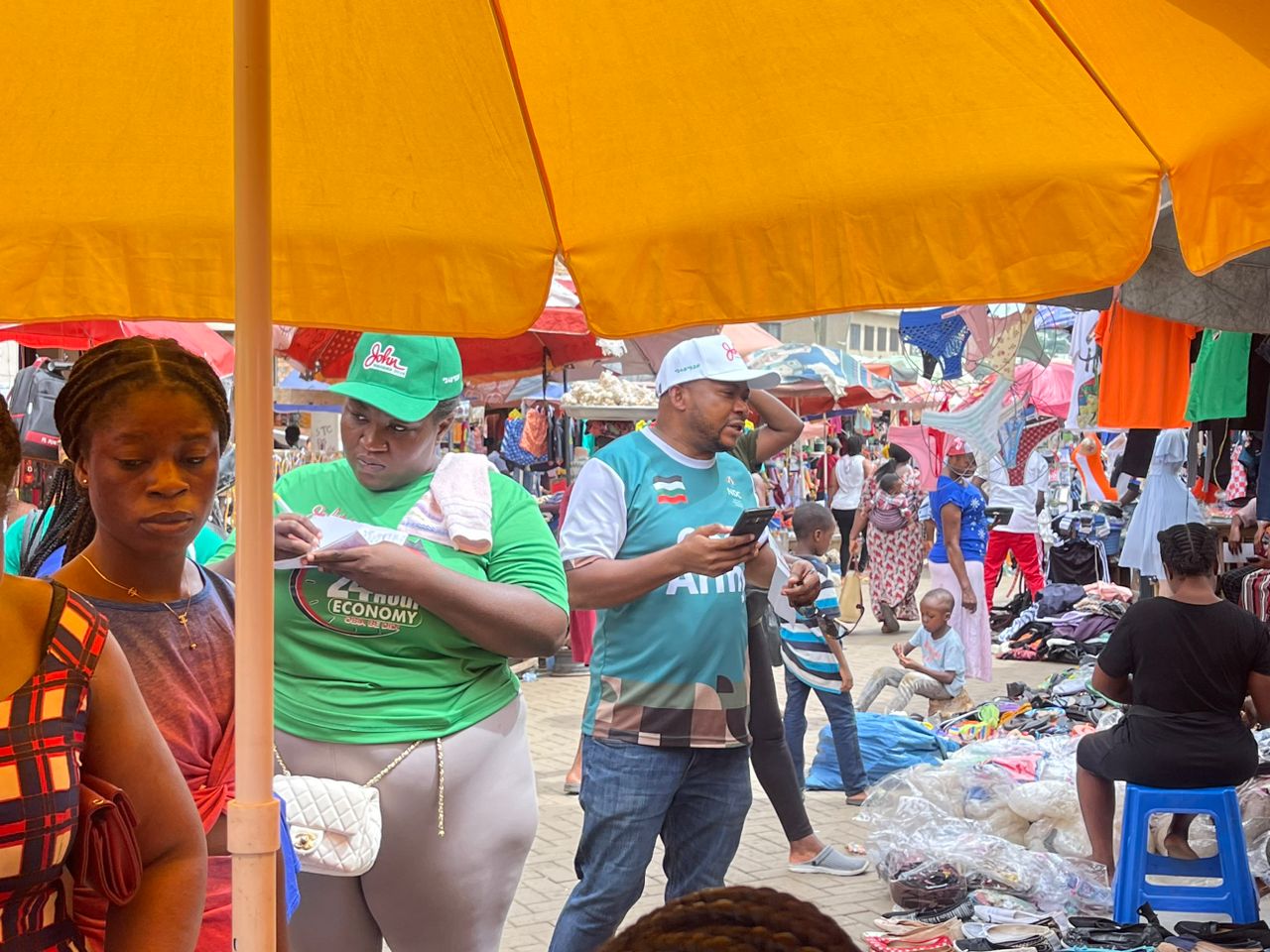 Mathias Johnson Alagbo, Volta Regional NDC Youth Organizer leads NDC Youth to tour Ho Market to interact with market women