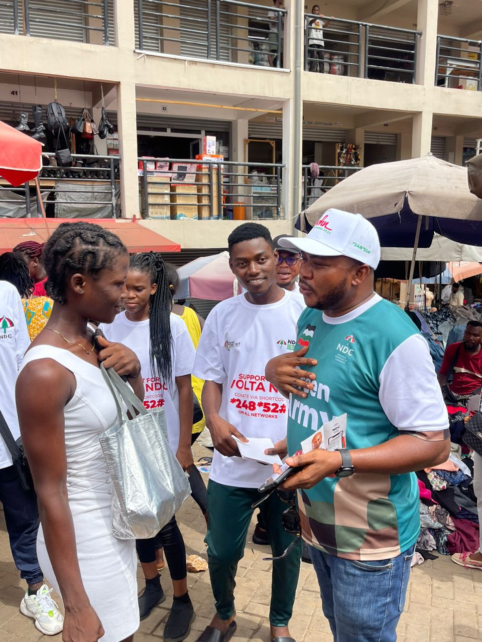Mathias Johnson Alagbo, Volta Regional NDC Youth Organizer leads NDC Youth to tour Ho Market to interact with market women